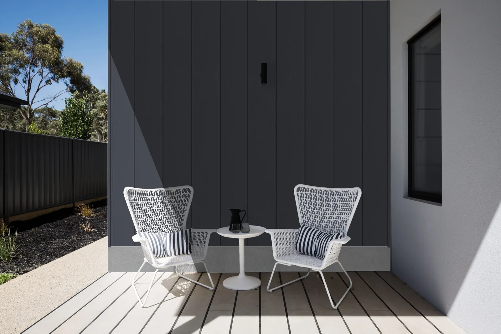 Fortex Clic 180 vertical slate grey cladding on a modern outdoor seating wall